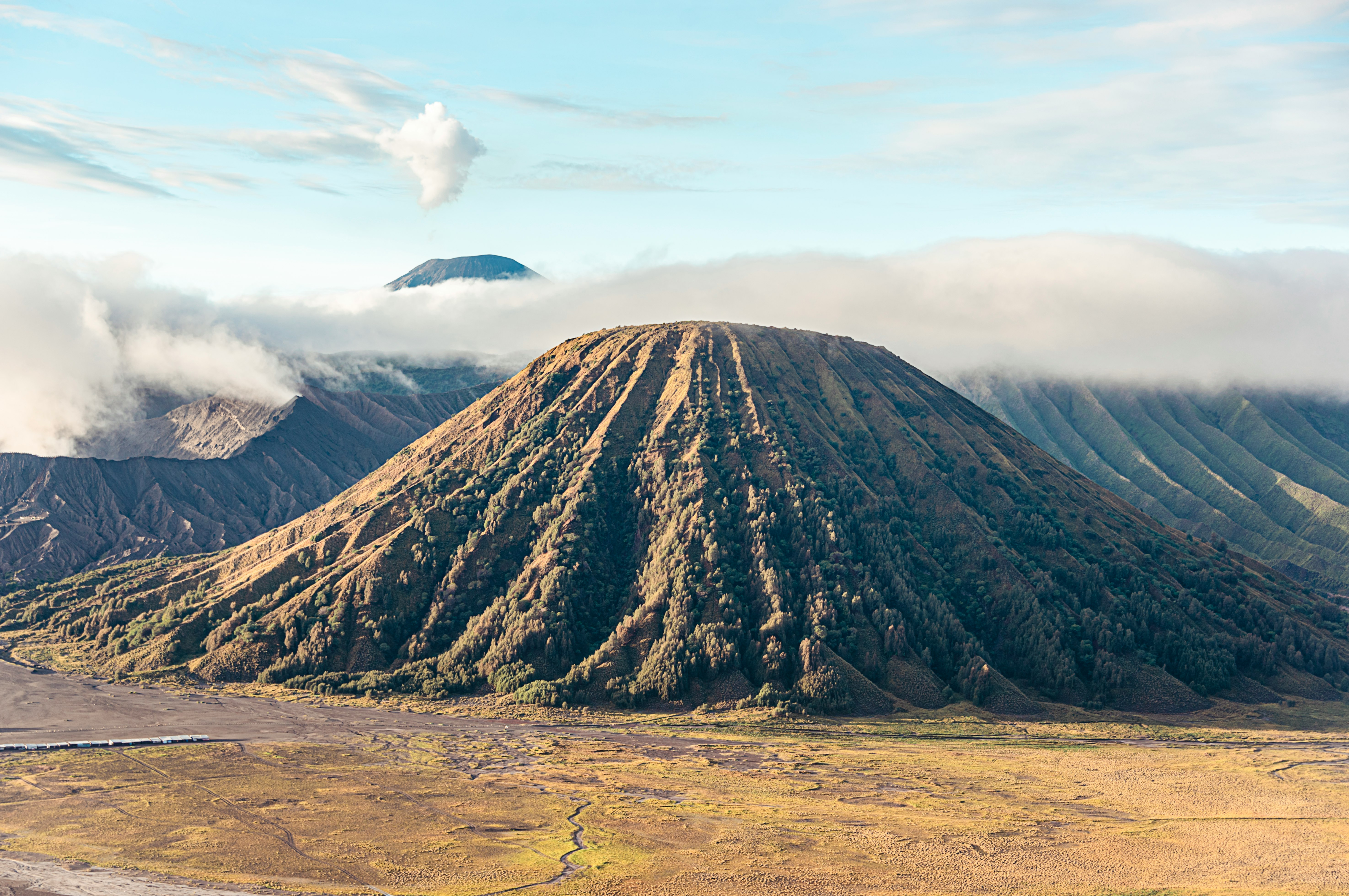 brown and black mountain under white clouds during daytime